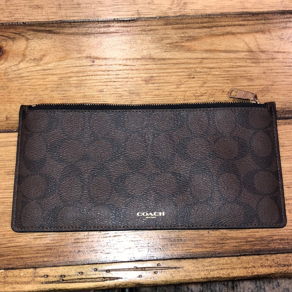 Brown and black Coach wallet/clutch